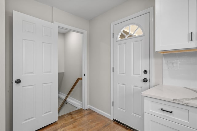 entrance foyer featuring baseboards and light wood-type flooring