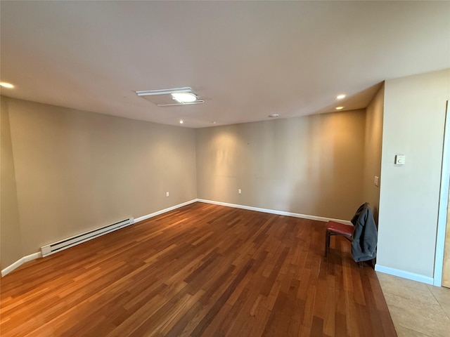 unfurnished room with recessed lighting, a baseboard heating unit, baseboards, and wood finished floors