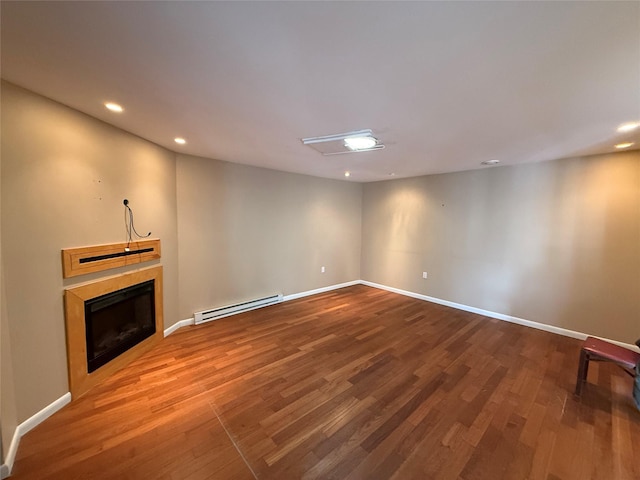 unfurnished living room with a fireplace, wood finished floors, baseboards, and a baseboard radiator