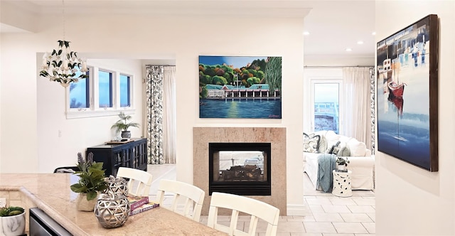 dining space with a multi sided fireplace, recessed lighting, tile patterned floors, and an inviting chandelier