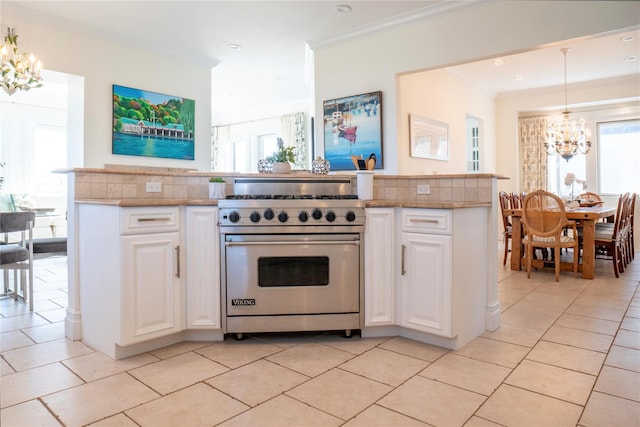 kitchen featuring ornamental molding, white cabinetry, an inviting chandelier, designer stove, and light tile patterned flooring