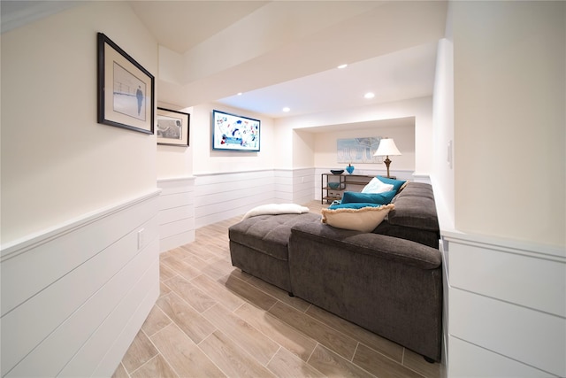 living area featuring recessed lighting, wainscoting, and wood tiled floor