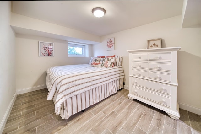 bedroom with wood finish floors and baseboards