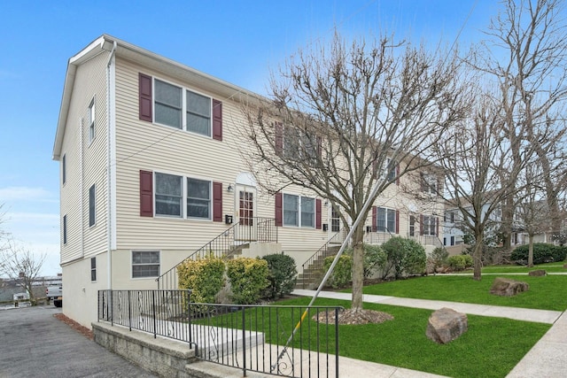 view of property with a front lawn and fence