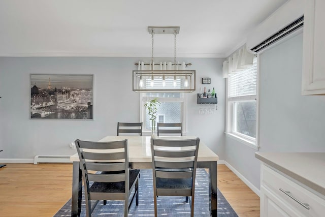 dining space with baseboard heating, light wood-type flooring, baseboards, and ornamental molding