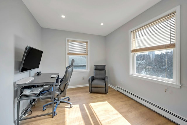 office space featuring recessed lighting, baseboards, baseboard heating, and wood finished floors