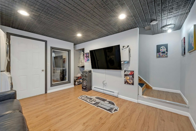 living area featuring recessed lighting, wood finished floors, baseboards, and baseboard heating