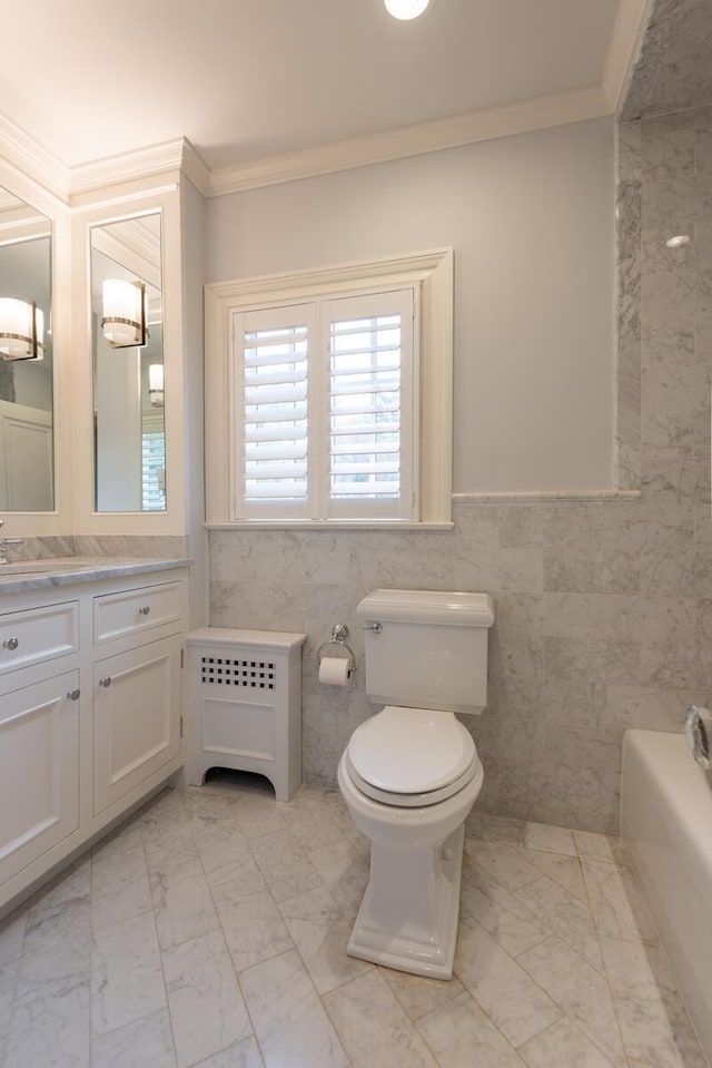 full bath with vanity, ornamental molding, tile walls, toilet, and marble finish floor