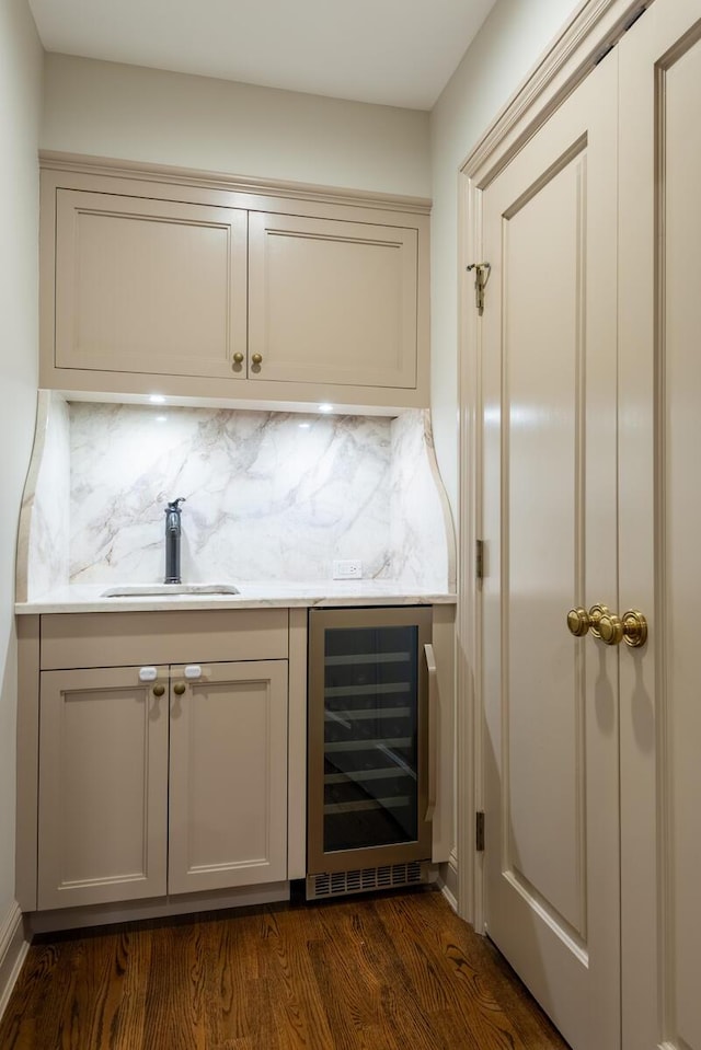 bar with dark wood-style flooring, a sink, wine cooler, a dry bar, and backsplash