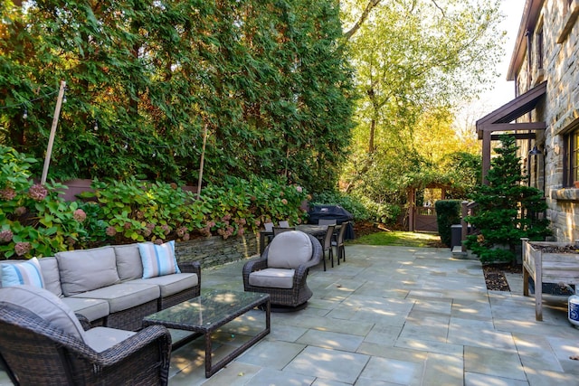 view of patio with a grill, fence, and an outdoor hangout area