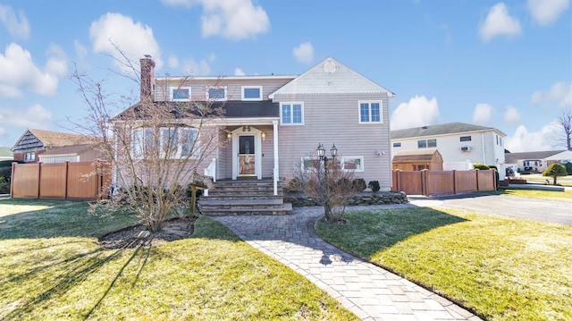 view of front of property with a front yard and fence