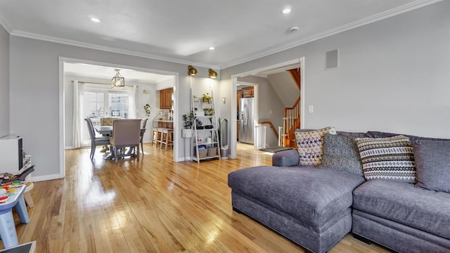 living room with stairway, baseboards, light wood-style flooring, recessed lighting, and ornamental molding