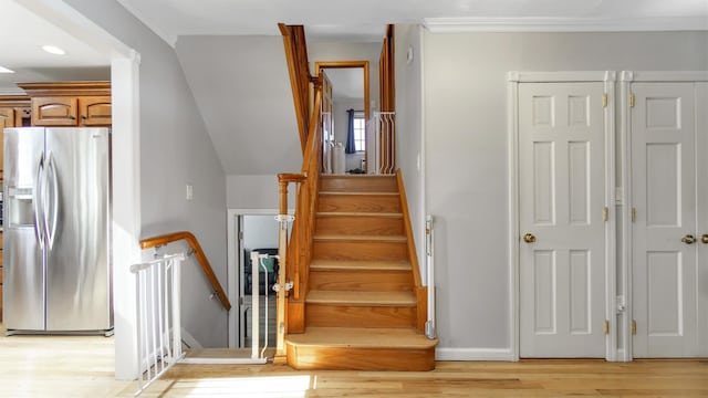 stairway featuring baseboards and wood finished floors