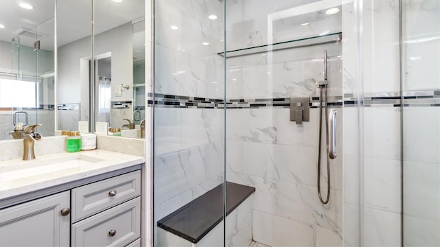 full bath with vanity, backsplash, and a marble finish shower