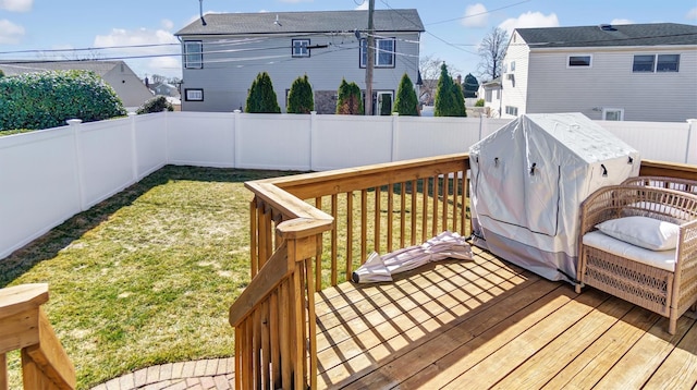 deck featuring a yard, a grill, and a fenced backyard