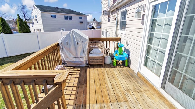 wooden terrace with area for grilling and fence