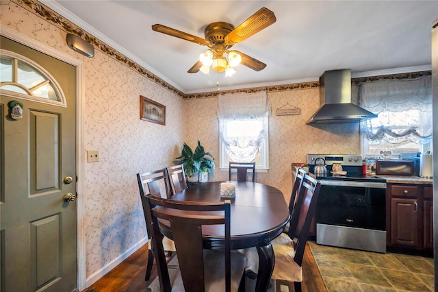 dining space with ceiling fan, wallpapered walls, crown molding, and baseboards