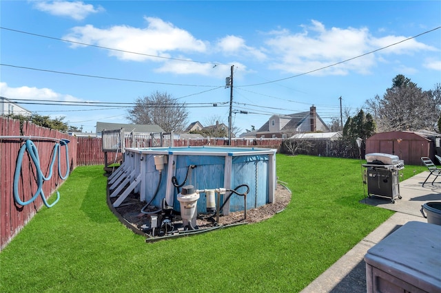 view of yard with a fenced in pool, an outdoor structure, a storage shed, and a fenced backyard