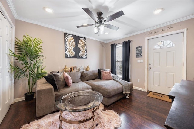 living area with a ceiling fan, wood finished floors, baseboards, and ornamental molding