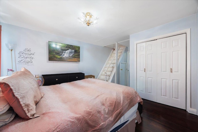 bedroom with a closet and dark wood-style flooring