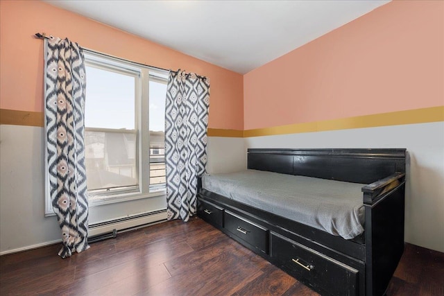 bedroom featuring baseboard heating and dark wood-style flooring