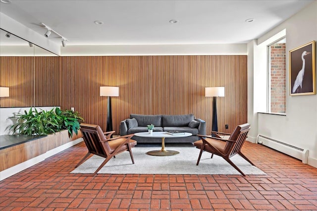 living area with brick floor and a baseboard radiator