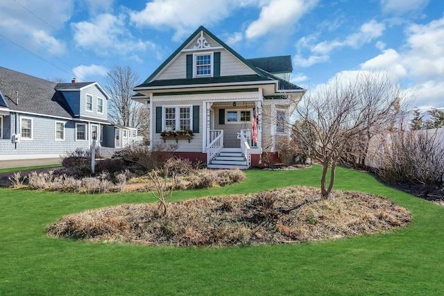 view of front of property with a porch and a front yard