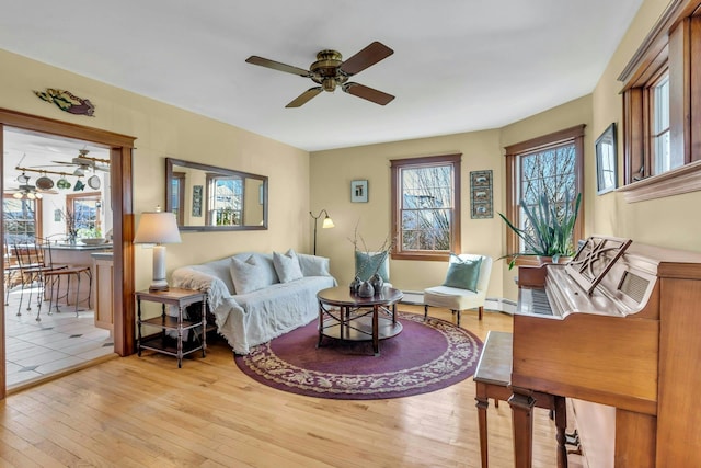 living room featuring ceiling fan and light wood-style floors