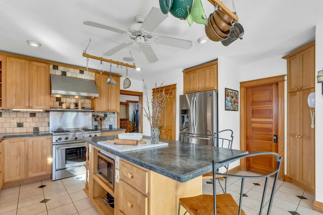 kitchen featuring range hood, stainless steel appliances, decorative backsplash, dark countertops, and a center island