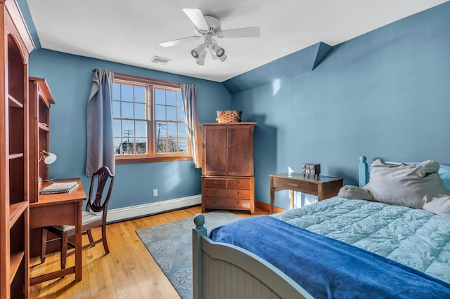 bedroom featuring baseboards, visible vents, a baseboard radiator, lofted ceiling, and light wood-style floors