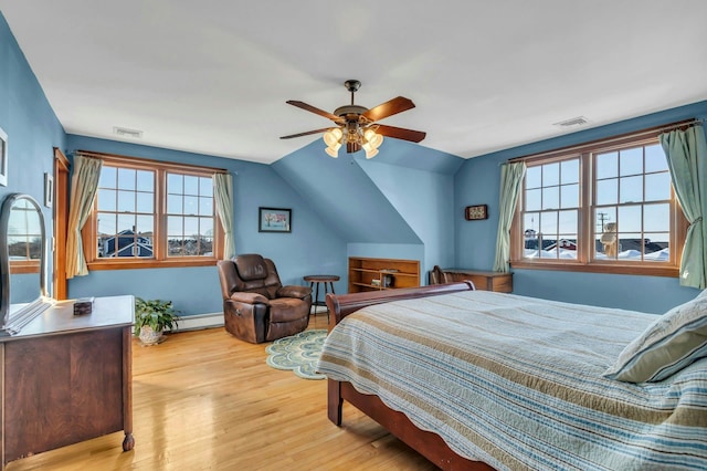 bedroom with visible vents, a ceiling fan, lofted ceiling, and wood finished floors