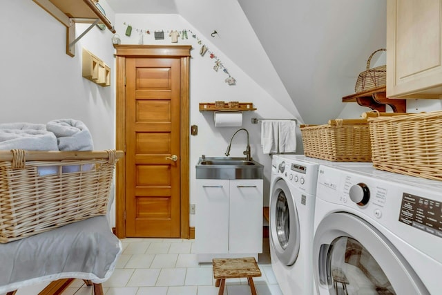 clothes washing area featuring a sink, cabinet space, and washer and clothes dryer