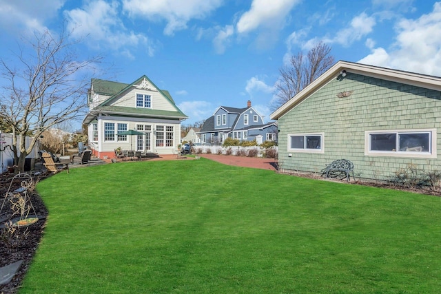 rear view of property with a yard and fence