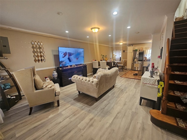 living room with stairway, recessed lighting, light wood-style floors, and ornamental molding