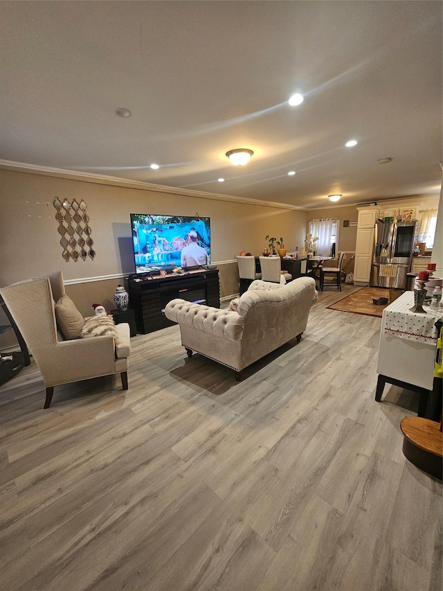 living area featuring recessed lighting and light wood-style flooring