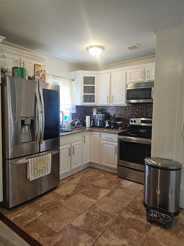 kitchen featuring stainless steel appliances, visible vents, decorative backsplash, and white cabinetry