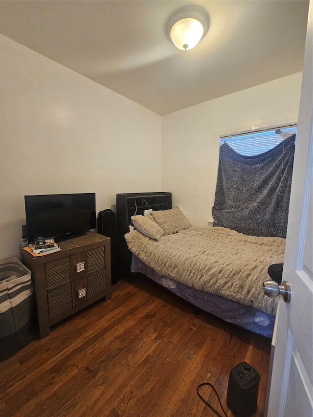 bedroom with dark wood-style floors