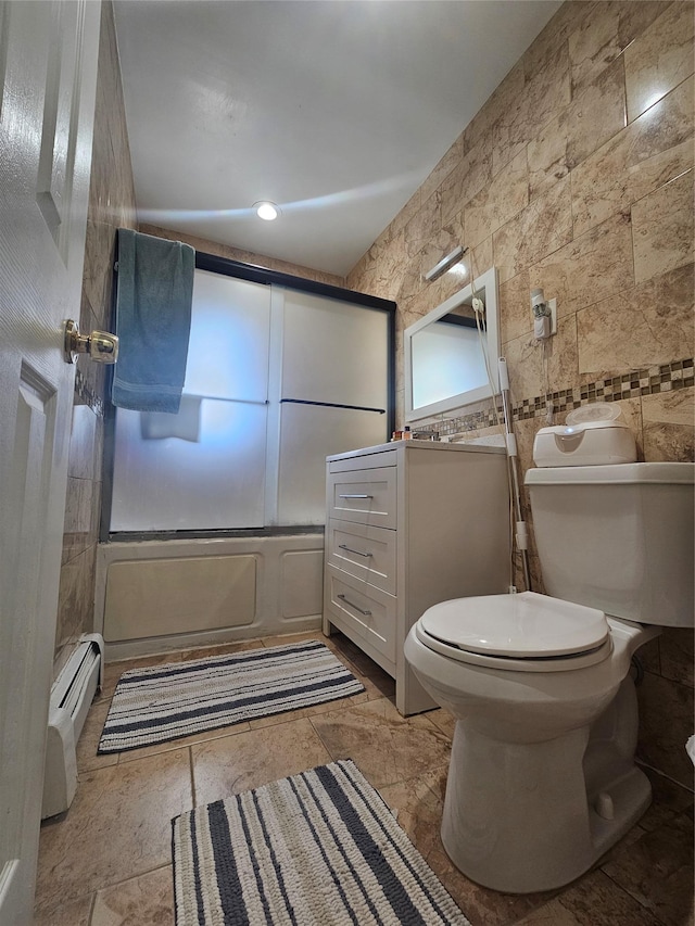 full bath featuring toilet, tile walls, a shower, baseboard heating, and vanity