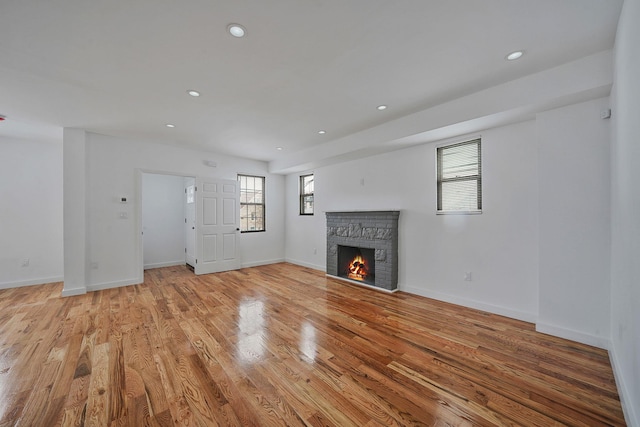 139-19 230th St, Laurelton, NY 11413 - unfurnished living room with baseboards, light wood finished floors, recessed lighting, and a fireplace