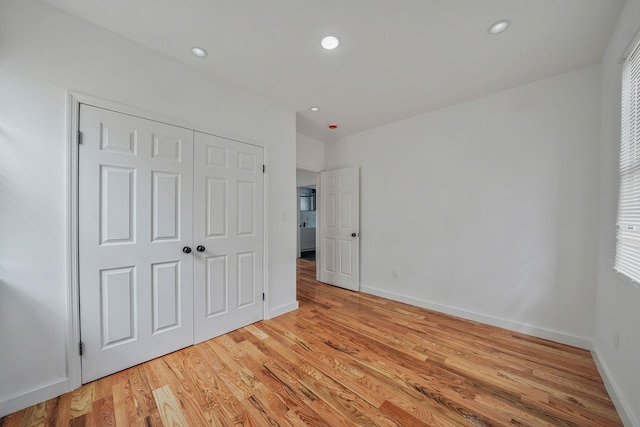 139-19 230th St, Laurelton, NY 11413 - unfurnished bedroom featuring a closet, light wood finished floors, baseboards, and recessed lighting