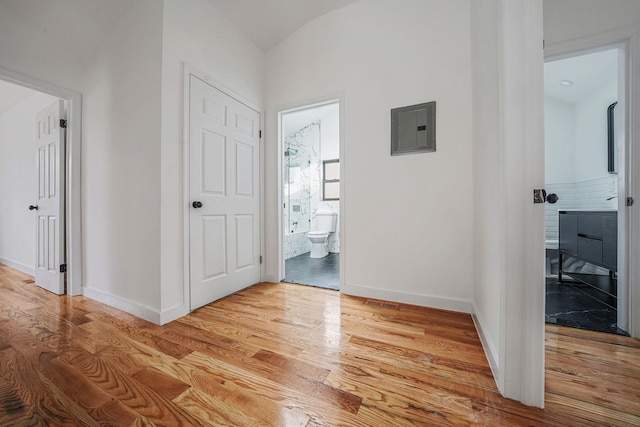 139-19 230th St, Laurelton, NY 11413 - corridor featuring baseboards, light wood finished floors, and electric panel