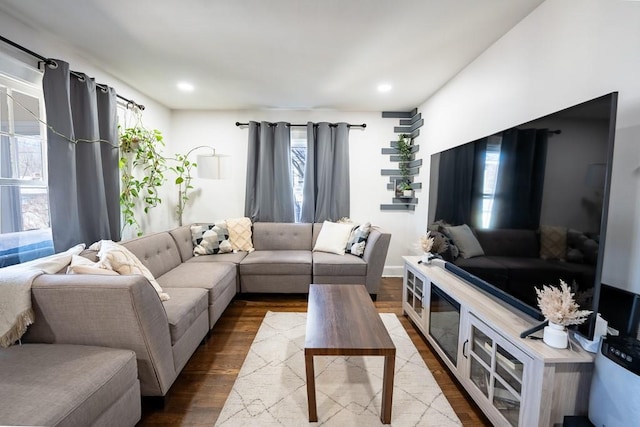 living area with recessed lighting and dark wood-style floors