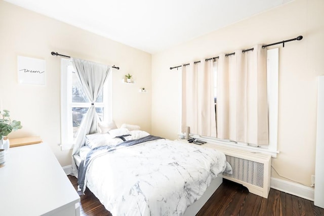 bedroom featuring baseboards and dark wood finished floors