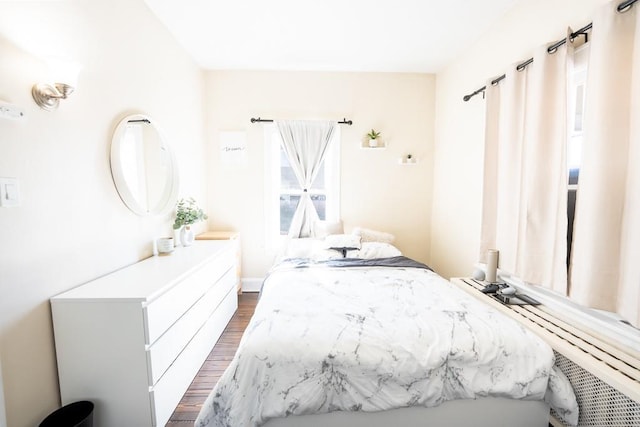 bedroom with dark wood-style flooring