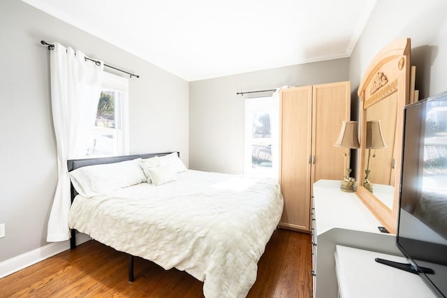 bedroom with baseboards and wood finished floors