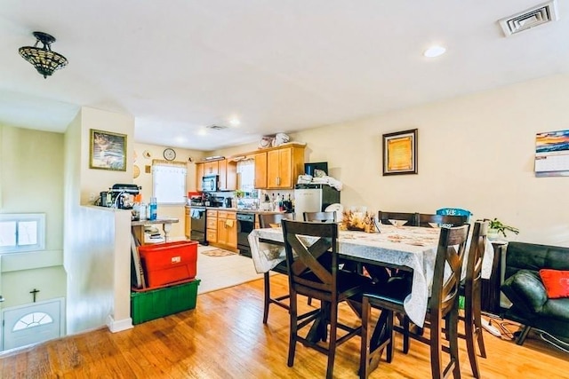 dining room with recessed lighting, visible vents, plenty of natural light, and light wood-type flooring