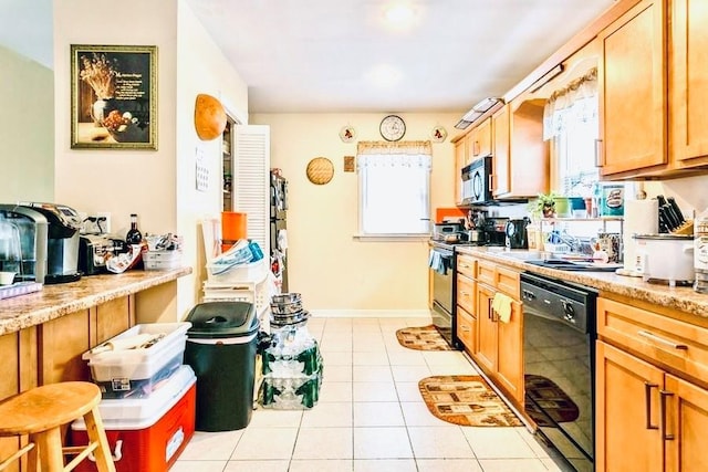 kitchen featuring black appliances, light tile patterned flooring, and baseboards