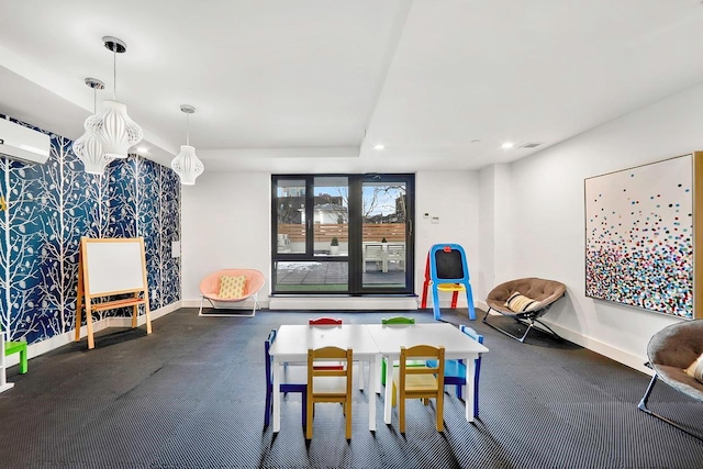 playroom with a wall mounted air conditioner, visible vents, baseboards, and recessed lighting