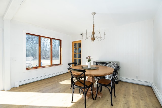 dining area with baseboard heating and light wood-style flooring