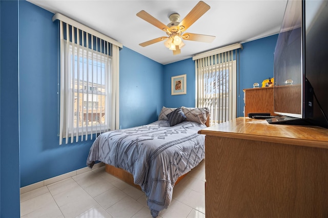 tiled bedroom featuring ceiling fan